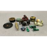 Three malachite carved animals, rhinoceros, lion and a whale together with a soapstone carving of