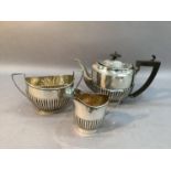 Three piece silver tea service of half reeded design