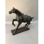 A reproduction bronze effect figure of a horse