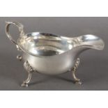 A GEORGE V SILVER SAUCE BOAT IN GEORGE III STYLE, gadrooned rim and acanthus capped scrolling