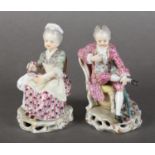 A PAIR OF DRESDEN-STYLE CHINA FIGURES each sitting on a salon chair, he with tricorn hat and