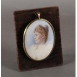 AN EDWARD VII HEAD AND SHOULDER PORTRAIT OF A YOUNG WOMAN, watercolour on ivory, 8.5cm x 6.75cm;