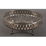 A GEORGE V SILVER CIRCULAR DISH with floral cast rim, the body pierced with stylized leafage, dished
