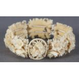 A LATE 19TH/EARLY 20TH CENTURY IVORY PANEL BRACELET of eight finely carved and pierced plaques,