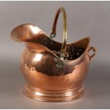 A VICTORIAN COPPER COAL HELMET with brass swing handle, 34.5cm wide x 26cm high