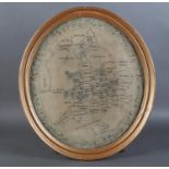 A LATE GEORGE III OVAL NEEDLEWORK MAP OF THE BRITISH ISLES worked in black thread within a floral