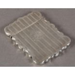 A VICTORIAN SILVER CARD CASE of shaped rectangular form, engraved with foliate scroll borders,