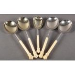 A SET OF FIVE IVORY HANDLED SILVER PLATED SERVING SPOONS to include a sifter spoon, each with finely