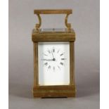 A BRASS CASED REPEATING CARRIAGE CLOCK with angular swing handle, reeded case throughout, the