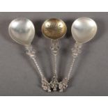 A PAIR OF GEORGE V SILVER SPOONS with fig shaped bowls, the stems cast at the base with a