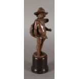 A LATE 19TH CENTURY ITALIAN BRONZE SCULPTURE OF A LIGHTLY CLAD INFANT wearing cape and hat, 18cm