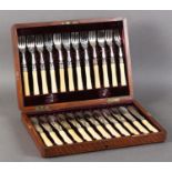 A SET OF TWELVE VICTORIAN SILVER PLATED FISH KNIVES AND FORKS with palmette and foliate engraved