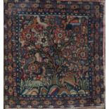 A 19TH CENTURY TURKEY WORK PANEL depicting a flowering tree and birds, rabbit and deer, within