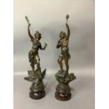 A pair of French spelter figures on turned socle bases 61cm high together with a resin bronze effect