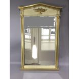 A cream and gilt wall mirror with triangular pediment, the frieze moulded with a two handled urn