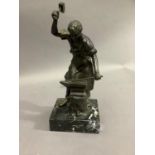A spelter figure of a blacksmith working at the anvil, marble base, 32cm high approx