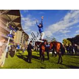 Frankie Dettori Signed Horse Racing Photograph in colour depicting Dettori jumping off horse winning