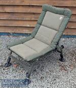 Nash Indulgence Recliner with padded green fabric seating with folding metal frame