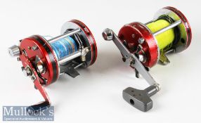 2x Abu Ambassadeur 7000 series multiplier reels in red and chrome construction, marked 760401 and