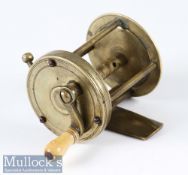 Early 19th Century wide spool brass multiplier reel with curved arm, stop latch to rim, three pillar