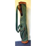 Green canvas and brown leather collapsible golf club carry tube bag with oval top, ball pocket and