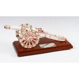 Arsenal FC presentation ceramic cannon on a wooden plinth decorated with red and gold having a