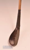 Interesting and unusual T Morris dark stained beech wood curved face short spoon with full brass