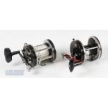 2x Abu Ambassadeur Multiplier Reels – 9000C with red handle having slight bend and 7000C with line