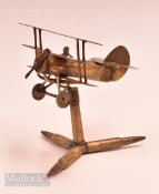 Trench Art - Brass Triplane Aeroplane, made from old brass and bullet pats, on a stand 14cm tall.
