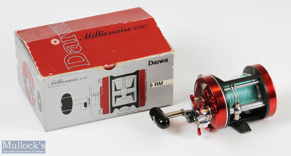 Daiwa Millionaire 6RM multiplier reel in red finish, star drag, counter balance handle, signs of
