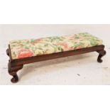 MAHOGANY FRAMED FOOT STOOL with a floral covered stuffover top, standing on stout cabriole supports,