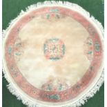 CIRCULAR CHINESE WASH RUG the pink border with floral motifs around a mushroom coloured ground,