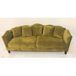 LARGE OLIVE GREEN VELVET SHAPED BACK SOFA with shaped arms and five loose scatter cushions, standing