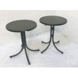 PAIR OF OAK EFFECT CURCULAR TILT TOPPED TABLES standing on folding four column metal supports,