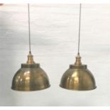 PAIR OF ANTIQUE BRASS EFFECT INDUSTRIAL PENDANT LIGHTS with domed shades and one with interior