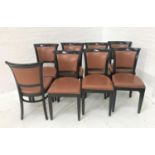 SET OF EIGHT DINING CHAIRS with shaped padded backs and seats in brown vinyl covering and with