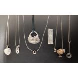 SEVEN VARIOUS SILVER PENDANTS including an ingot pendant with decorative hallmarks, 29.4 grams; a