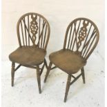 PAIR OF ELM WHEEL BACK KITCHEN CHAIRS with shaped backs and seats, standing on turned supports