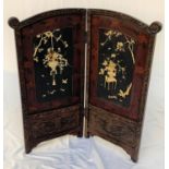 CHINESE EBONISED FOLDING SCREEN with floral and scroll border, the central panels decorated with