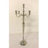 POLISHED STEEL FLOOR STANDING CANDELABRA with central drip pan and four branches, raised on a