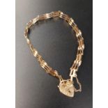 NINE CARAT GOLD GATE BRACELET with nine carat gold padlock clasp and safety chain, approximately 3.6