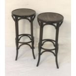 PAIR OF BENTWOOD BAR STOOLS with circular seats on shaped supports, 80cm high (2)