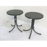 PAIR OF OAK EFFECT CURCULAR TILT TOPPED TABLES standing on folding four column metal supports,