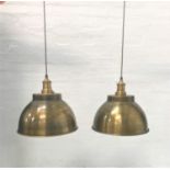 PAIR OF ANTIQUE BRASS EFFECT INDUSTRIAL PENDANT LIGHTS with domed shades and interior textured