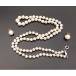 GRADUARED PEARL NECKLACE with individually knotted pearls, nine carat white gold barrel shaped clasp
