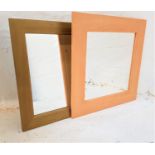 GOLD STAINED PINE WALL MIRROR with a square plate, 51.5cm x 51.5cm, together with a beech effect