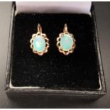 PAIR OF OPAL EARRINGS the oval opal on each within pierced lobed surround, in ten carat gold, with