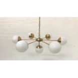 SIX BRANCH PENDANT LIGHT with opaque circular glass shades and brass effect suspension chain, and