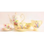 FOLEY PART TEA SERVICE with a pale yellow ground and floral decoration, comprising a sandwich and