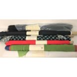 EIGHT ROLLS OF VARIOUS FABRICS including white satin, patterned silk, red imitation leather, green